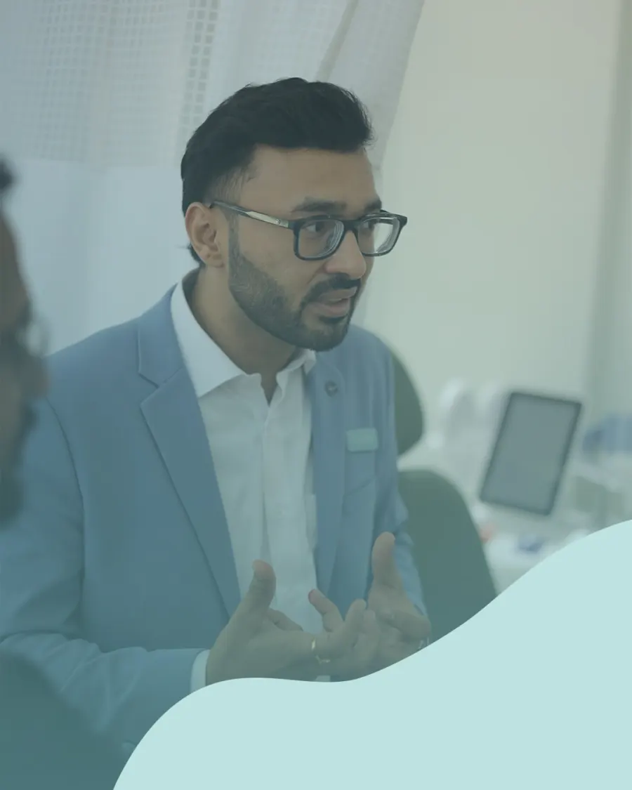 Dr. Dhrumit Gohil speaking with guests at Izumi
